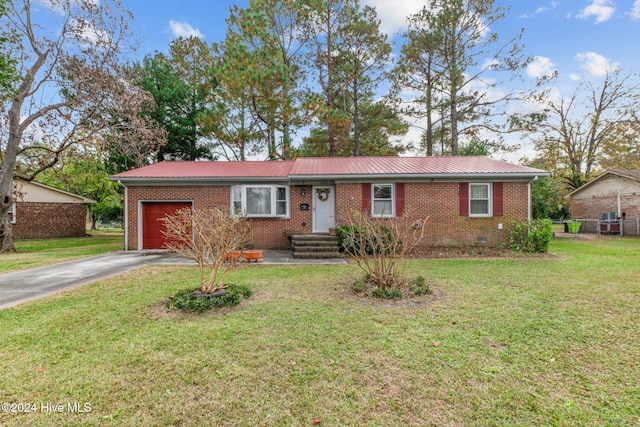 ranch-style house featuring a front lawn and a garage