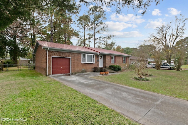 single story home featuring a garage and a front lawn