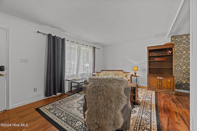 bedroom featuring hardwood / wood-style floors and a textured ceiling