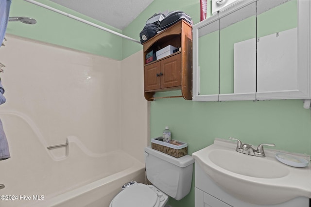 full bathroom featuring shower / bathing tub combination, vanity, a textured ceiling, and toilet