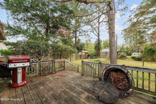 deck featuring a lawn and grilling area