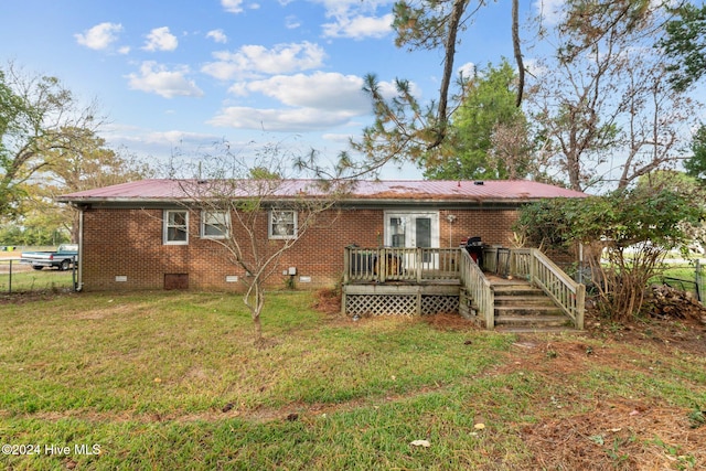 rear view of property with a lawn