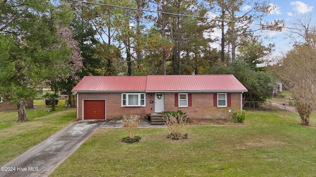 ranch-style house featuring a garage and a front yard