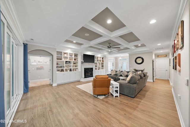 living room featuring coffered ceiling, beamed ceiling, light wood-type flooring, and ceiling fan