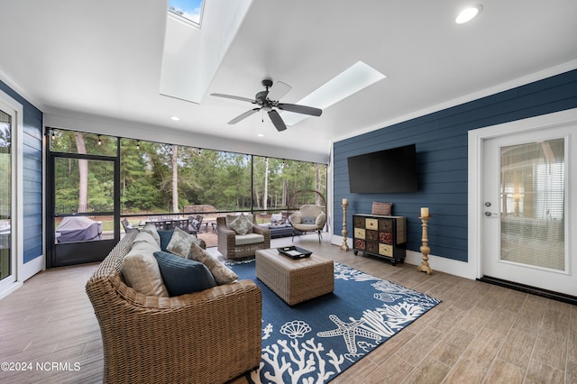 living room featuring ceiling fan and light hardwood / wood-style flooring