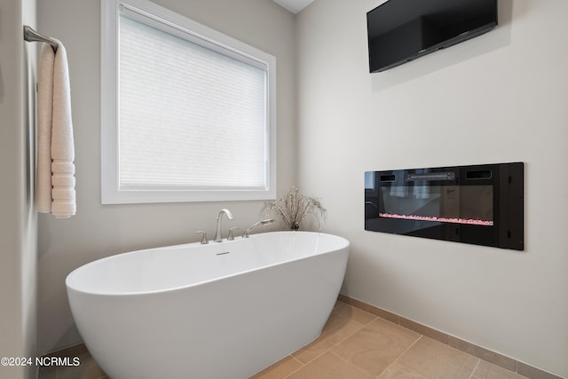 bathroom featuring a bath and tile patterned floors