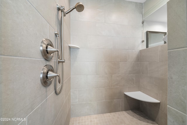 bathroom with a tile shower