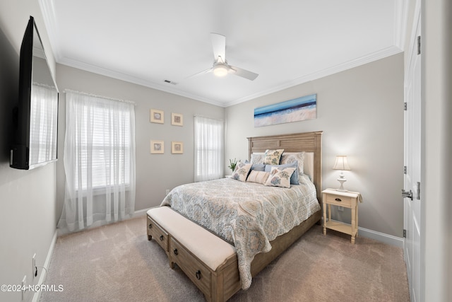 bedroom featuring ceiling fan, crown molding, and carpet flooring