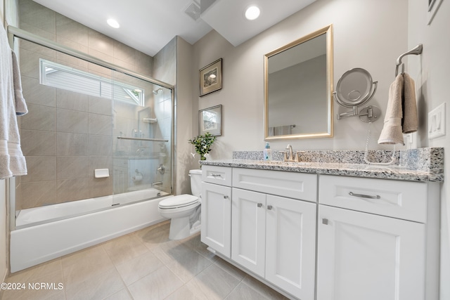 full bathroom featuring bath / shower combo with glass door, vanity, toilet, and tile patterned floors