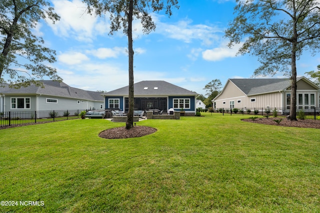 back of property with a yard and a patio