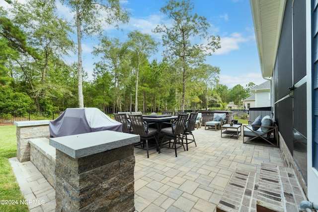 view of patio with grilling area and outdoor lounge area