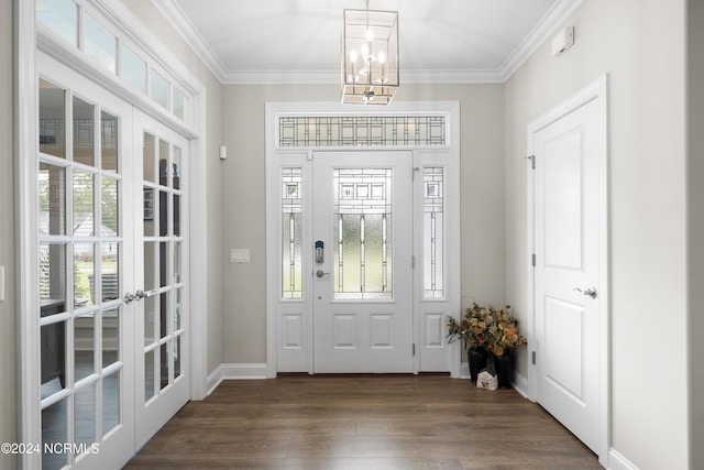 entryway featuring french doors, ornamental molding, a chandelier, and dark wood-type flooring