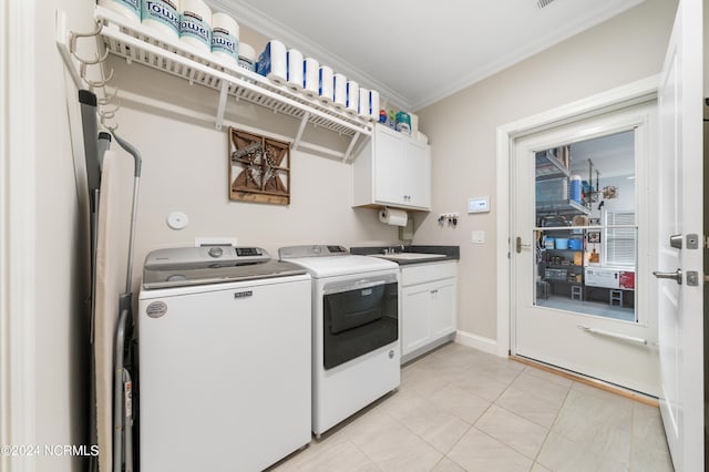 laundry area with light tile patterned flooring, sink, cabinets, independent washer and dryer, and crown molding