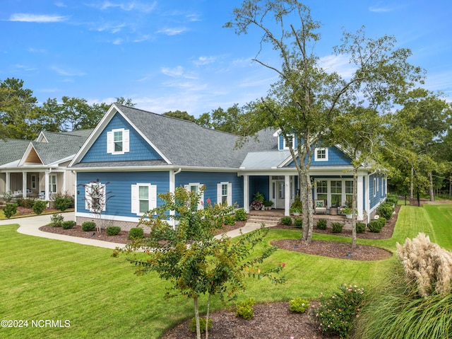 view of front facade featuring a front lawn and covered porch