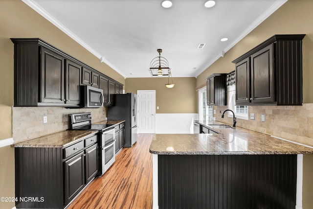 kitchen with light hardwood / wood-style floors, sink, ornamental molding, and stainless steel appliances