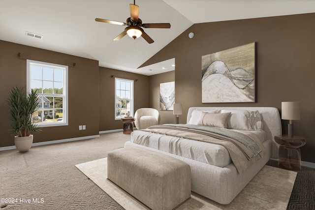 bedroom featuring ceiling fan, light colored carpet, and vaulted ceiling