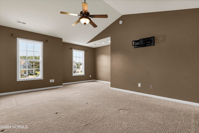 carpeted spare room featuring ceiling fan and lofted ceiling