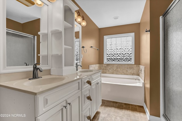 bathroom with tile patterned flooring, vanity, and independent shower and bath