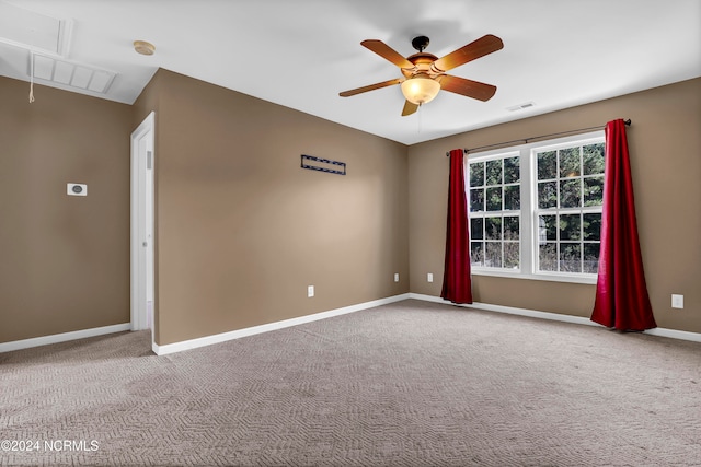 carpeted spare room with ceiling fan