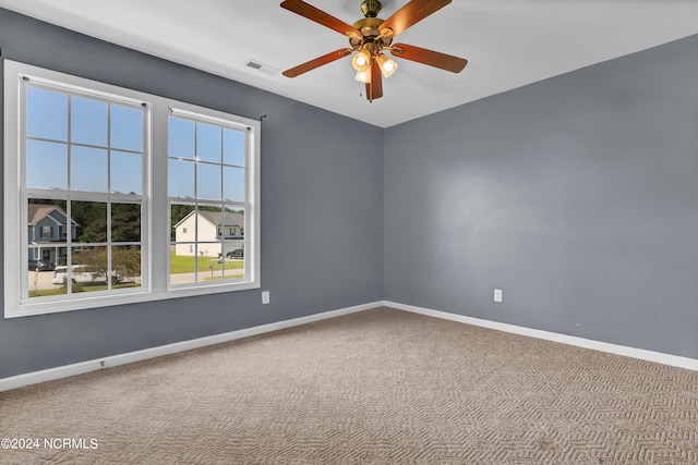 spare room with carpet and ceiling fan