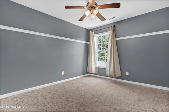 empty room featuring carpet floors and ceiling fan