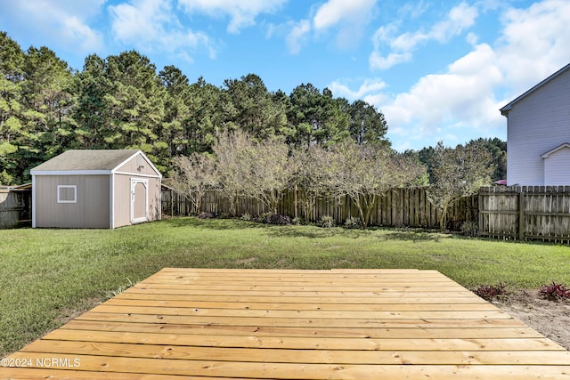 wooden deck with a yard and a storage shed