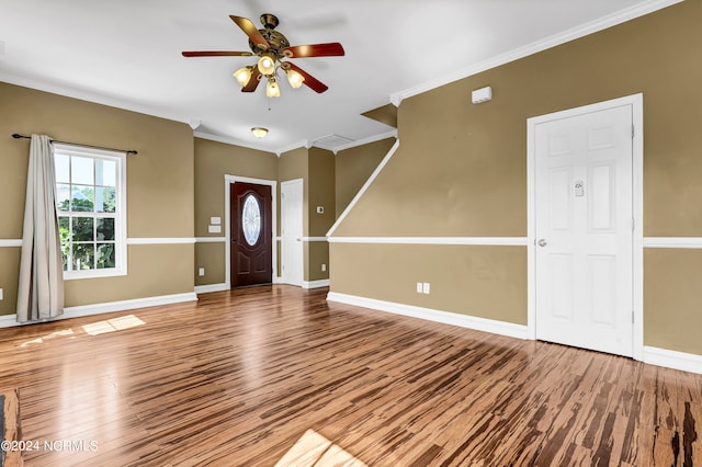 foyer entrance featuring ceiling fan, ornamental molding, and hardwood / wood-style flooring