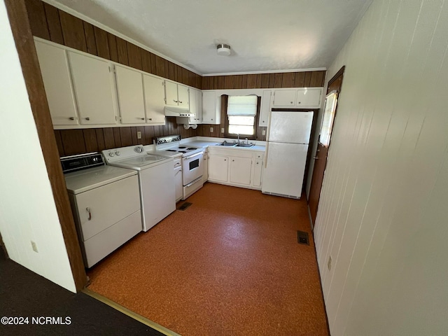 kitchen with white appliances, white cabinetry, sink, and washing machine and clothes dryer