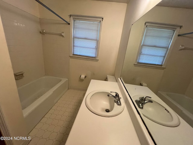 full bathroom featuring vanity, toilet, and tiled shower / bath