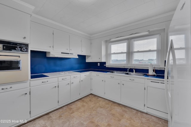 kitchen with under cabinet range hood, white appliances, a sink, white cabinetry, and ornamental molding