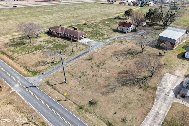 birds eye view of property with a rural view