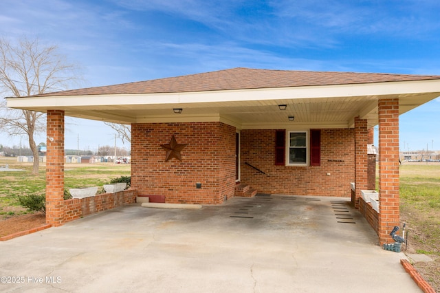 exterior space featuring an attached carport and concrete driveway