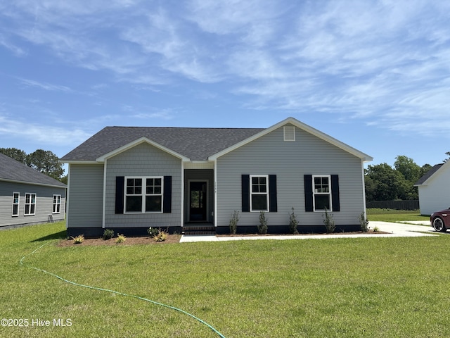1399 Hammocks Beach Rd, Swansboro, NC 28584 - ranch-style house with a front yard and roof with shingles