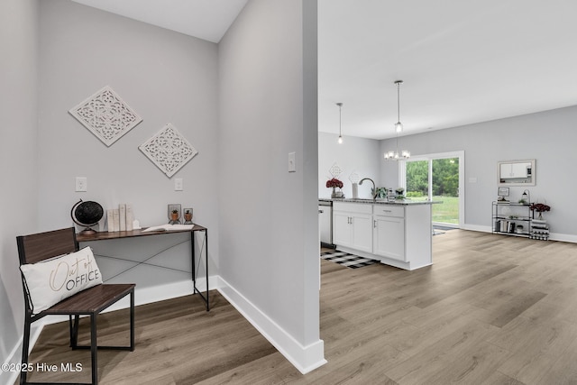 1399 Hammocks Beach Rd, Swansboro, NC 28584 - office space featuring light wood-style floors, a sink, a chandelier, and baseboards