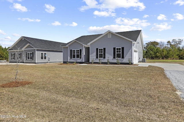 1399 Hammocks Beach Rd, Swansboro, NC 28584 - view of front facade with concrete driveway, central AC unit, a front lawn, and roof with shingles