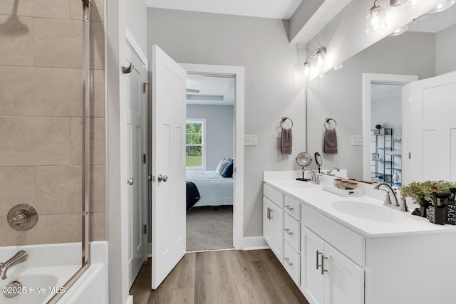 1399 Hammocks Beach Rd, Swansboro, NC 28584 - full bath with wood finished floors, double vanity, ensuite bathroom, washtub / shower combination, and baseboards