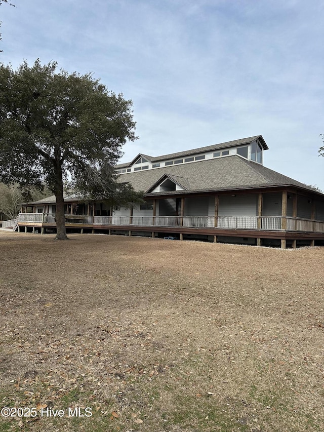 1399 Hammocks Beach Rd, Swansboro, NC 28584 - rear view of house featuring roof with shingles and a wooden deck