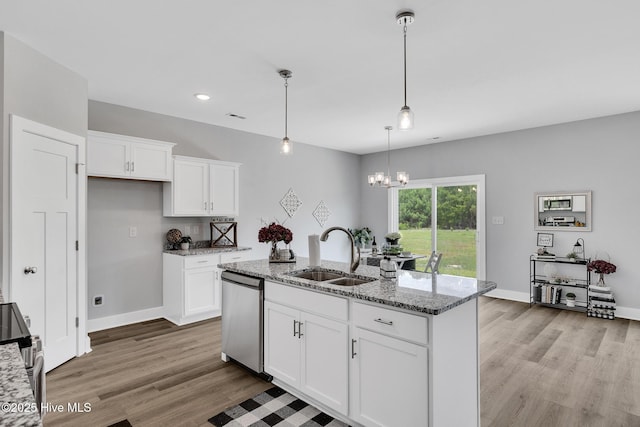 1399 Hammocks Beach Rd, Swansboro, NC 28584 - kitchen featuring stainless steel appliances, a sink, light stone countertops, light wood-style floors, and white cabinets