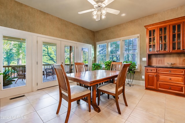 dining room with french doors, light tile patterned flooring, and ceiling fan