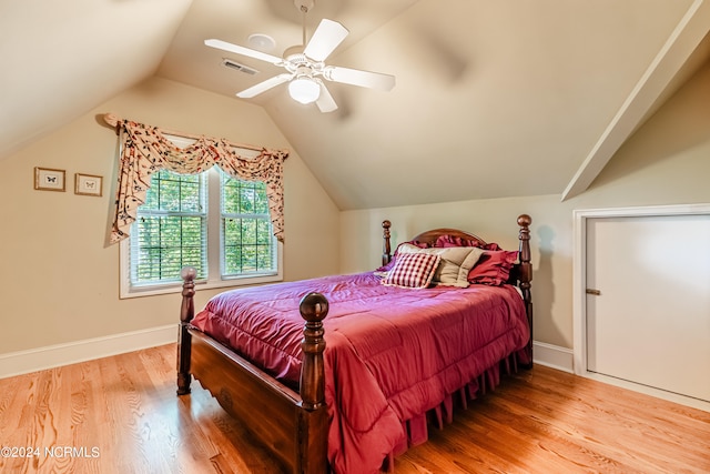 bedroom with ceiling fan, lofted ceiling, and hardwood / wood-style floors