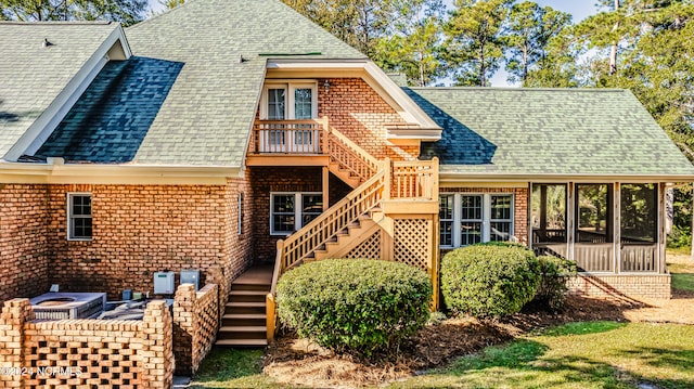 rear view of house featuring a sunroom