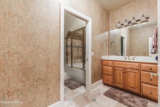 bathroom with vanity and enclosed tub / shower combo