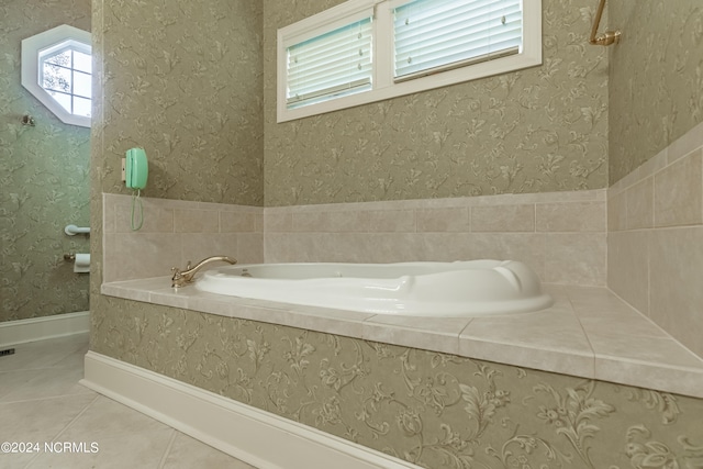 bathroom with tiled bath and tile patterned floors