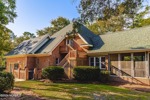 view of front of house featuring a front lawn and a sunroom