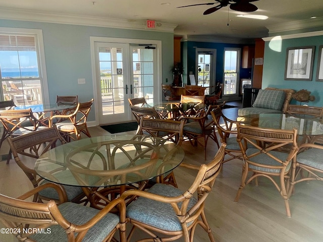 dining area featuring french doors, ornamental molding, light wood-type flooring, and ceiling fan