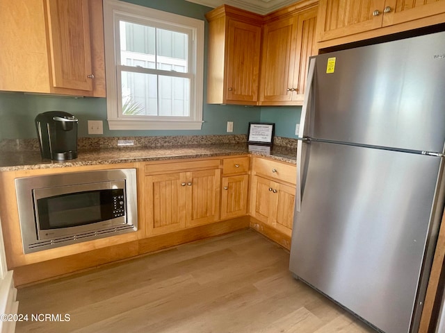 kitchen featuring stainless steel appliances and light wood-type flooring