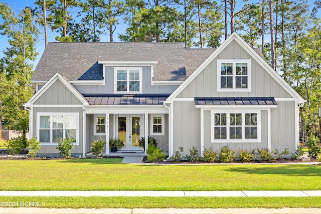 view of front of property featuring french doors and a front yard