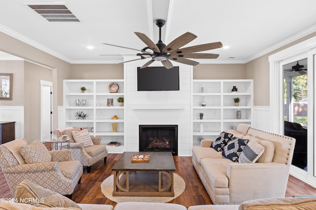 living room featuring a large fireplace, dark hardwood / wood-style floors, and ornamental molding