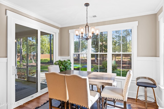 dining area with plenty of natural light and ornamental molding