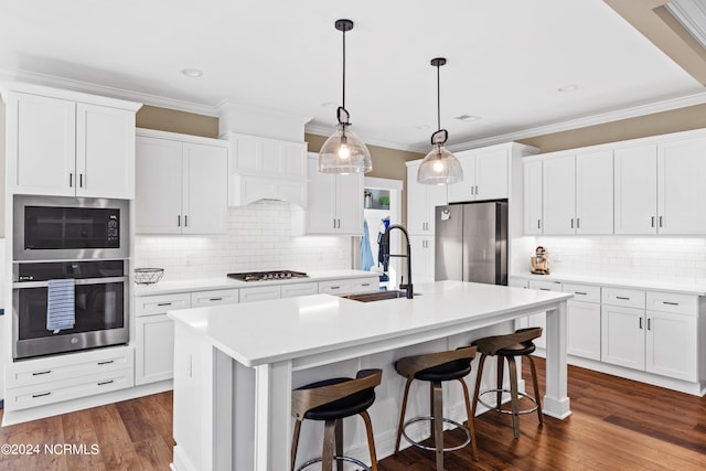 kitchen with sink, pendant lighting, a center island with sink, white cabinets, and appliances with stainless steel finishes